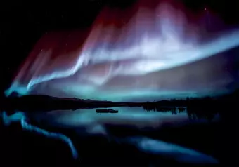 Wall Mural Beautiful aurora - nightscape with a lake and blue glow in the sky Wallpaper Cropper