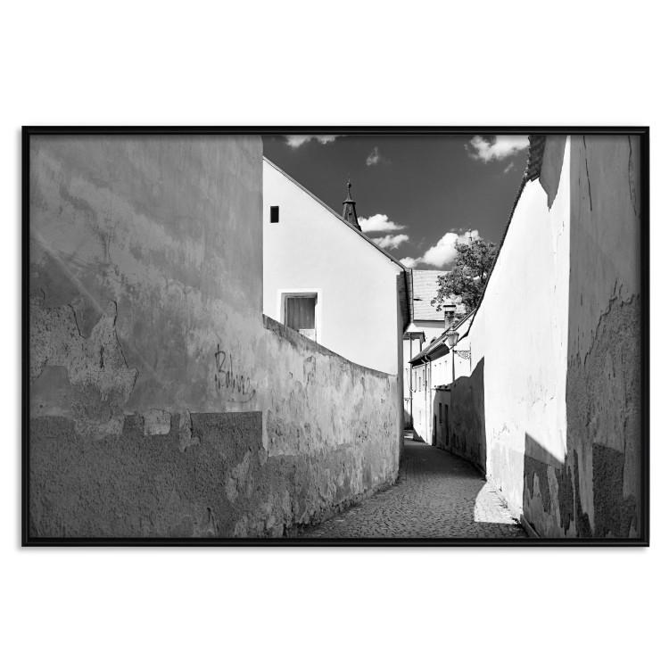 Poster Narrow alley - black and white urban street scene against architectural backdrop