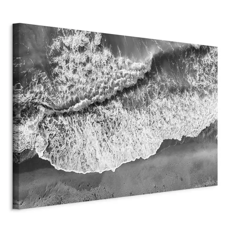 Ocean shore - black and white photograph of waves hitting the beach