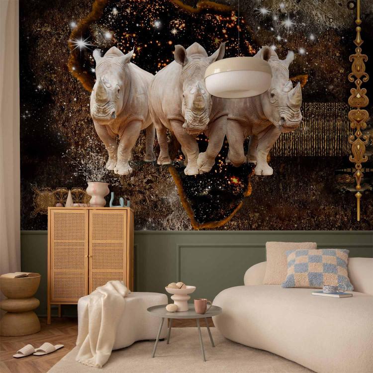 Wall Mural Three rhinoceros - animals on a night background with gold