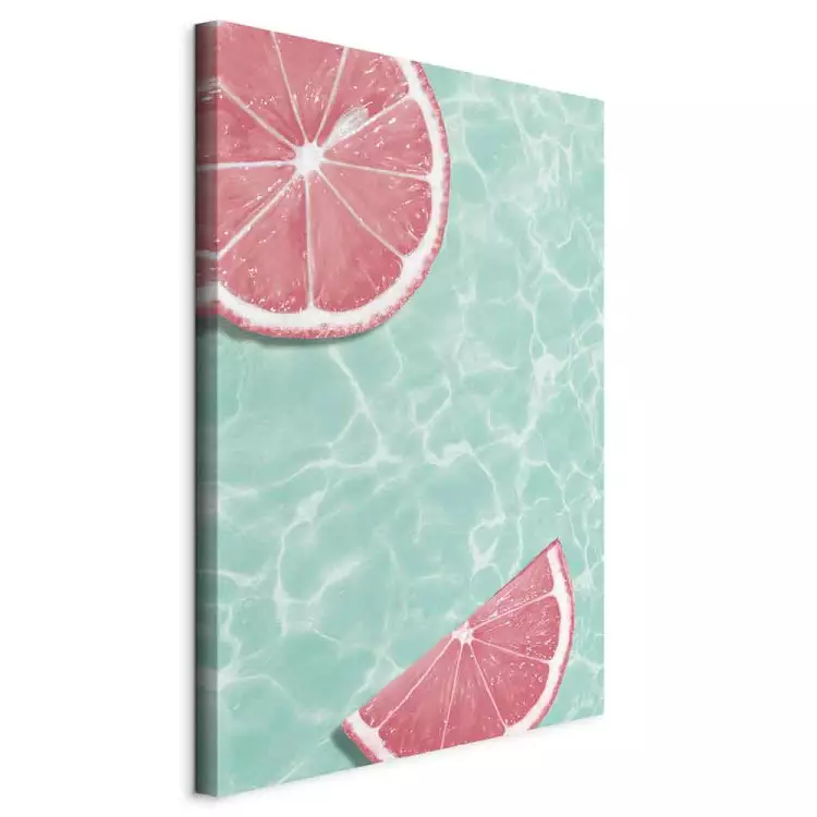 Grapefruit slices floating in turquoise water - summer abstraction