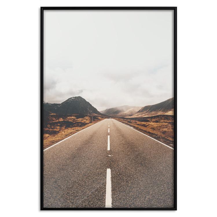 Poster Ahead - landscape of a road amidst yellow and black fields and mountains