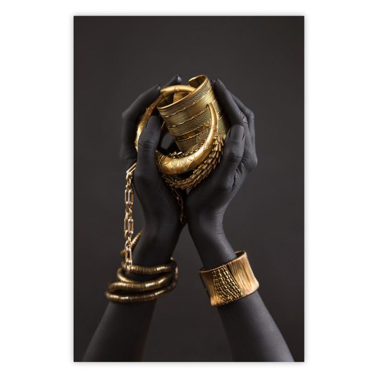 Poster Gold of the Desert - black hands with golden items on a dark background