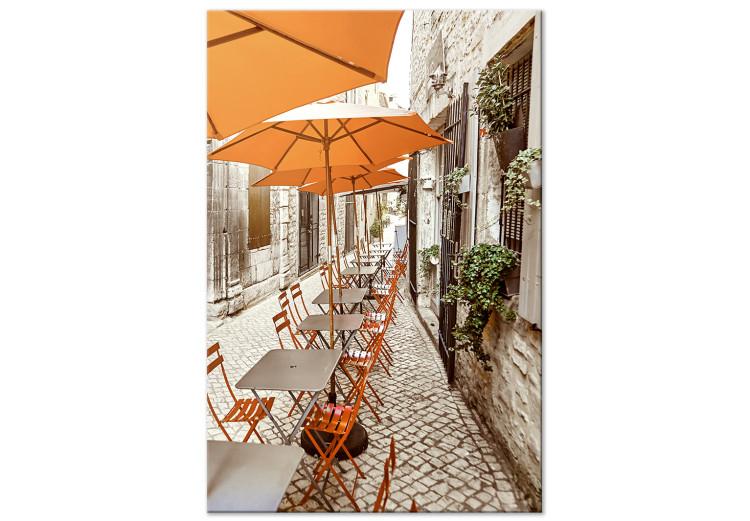 Canvas Italian Cafe - a photo of a narrow streets with tables and umbrellas