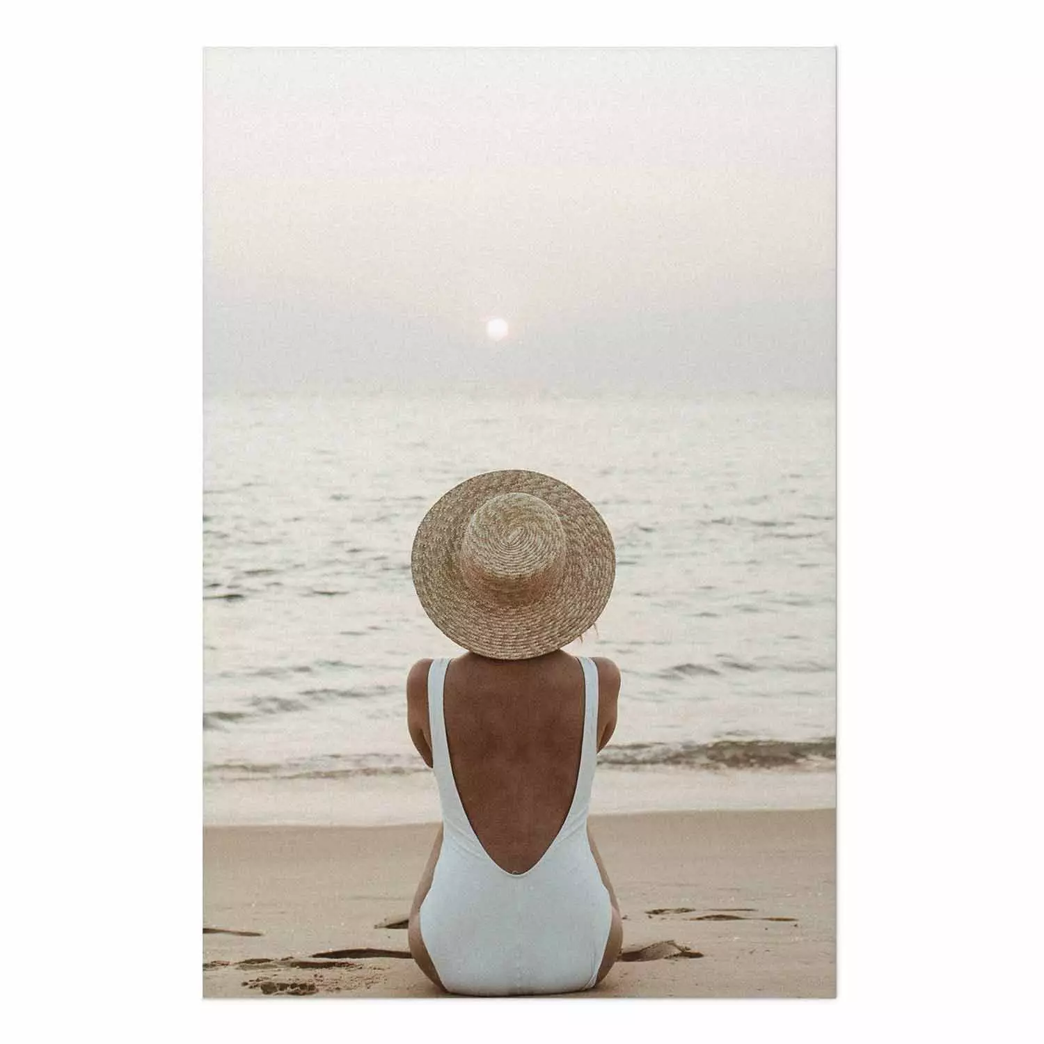 Wall Poster Beach Rest - woman sitting on the sand with sunset in the background