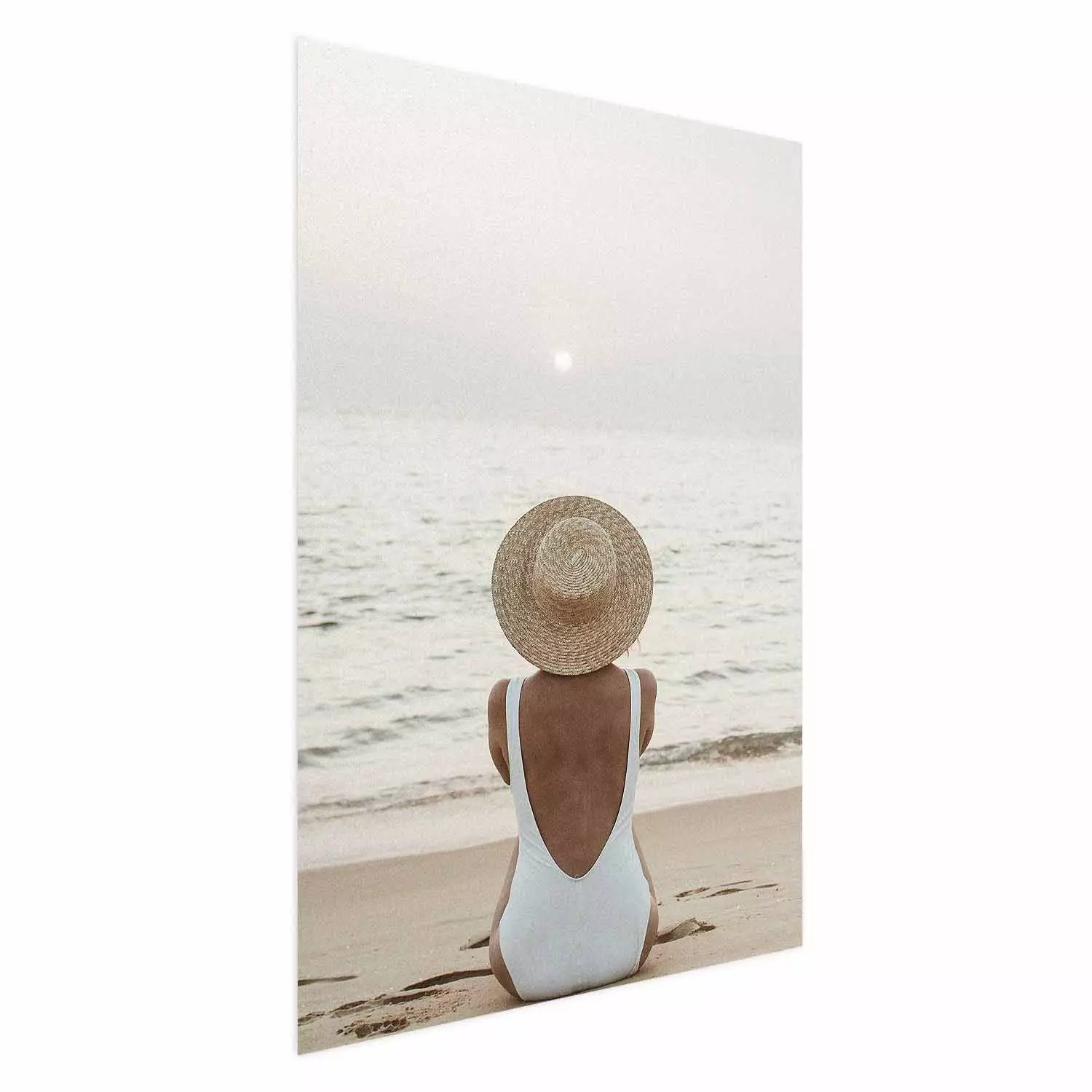 Wall Poster Beach Rest - woman sitting on the sand with sunset in the background