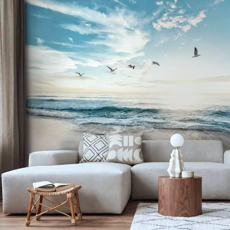 Wall Mural Abandoned beach - seascape with waves, birds and a setting sun