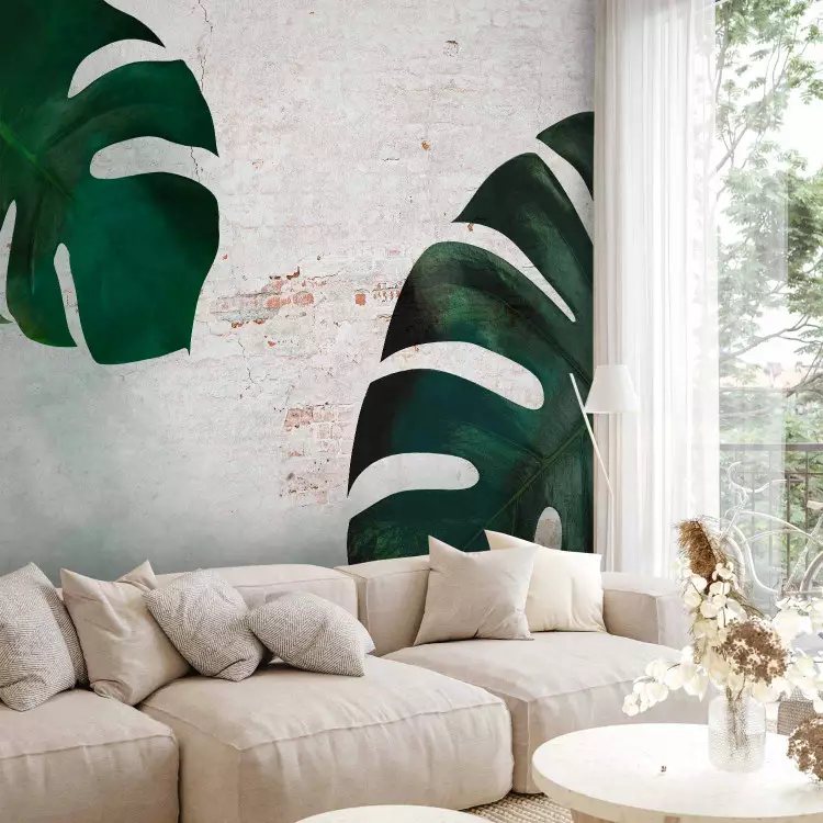 Exotic leaves - composition with monstera on a brick wall background