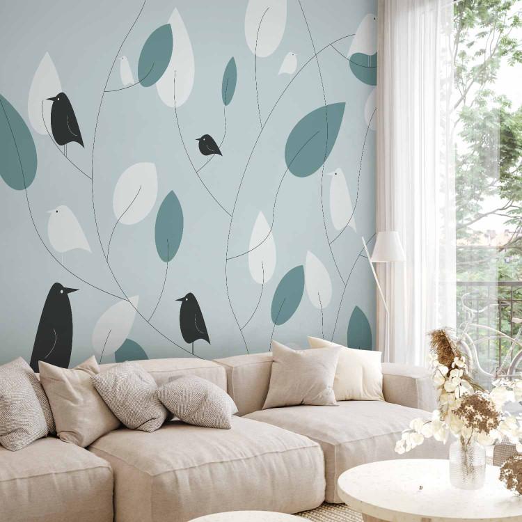 Wall Mural Landscape - black and white birds on a background with leaves in shades of blue