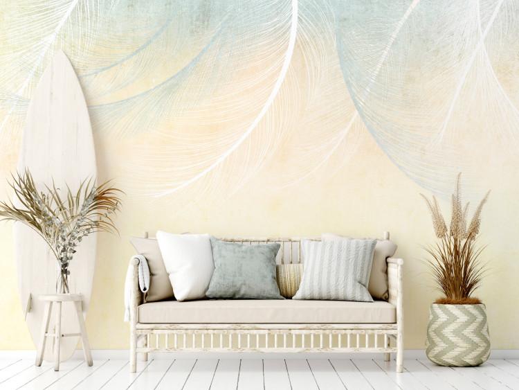 Wall Mural Natural veil - landscape with a composition of blue feathers on a yellow background