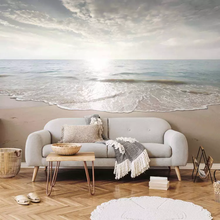 Sand and sun - landscape with calm sea and beach with footprints