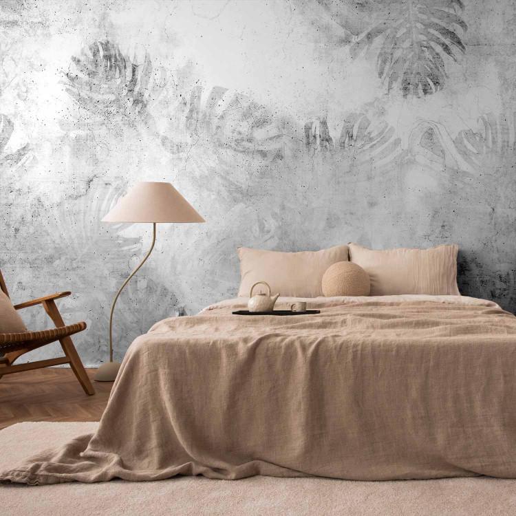 Wall Mural Monstera - landscape in grey with leaves on a concrete textured background