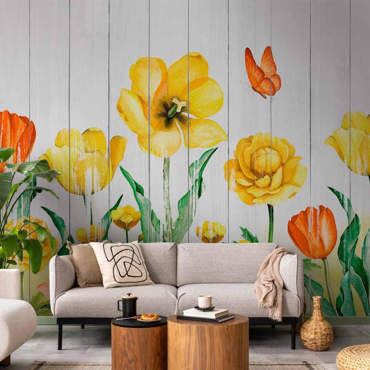 Wall Mural Tulips in a meadow - yellow flowers on a background of white wooden boards