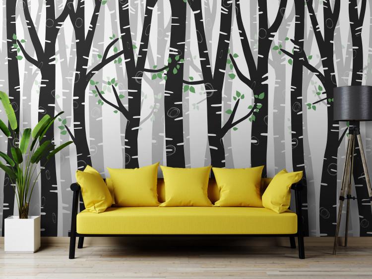 Wall Mural Birch forest - black and white trees with green leaves on branches