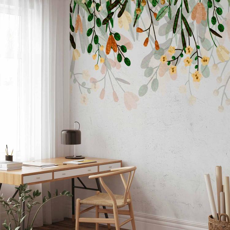 Wall Mural Vegetable meadow - nature motif with leaves and yellow flowers on concrete background