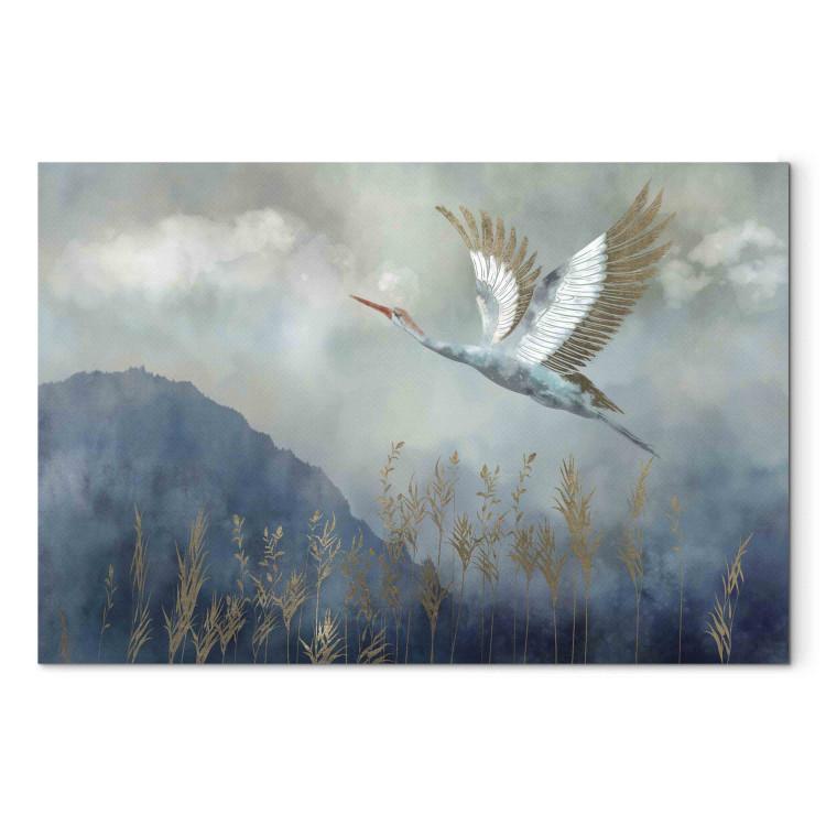 Canvas A Heron in Flight - A Bird Flying Against the Background of Dark Blue Mountains Covered With Fog