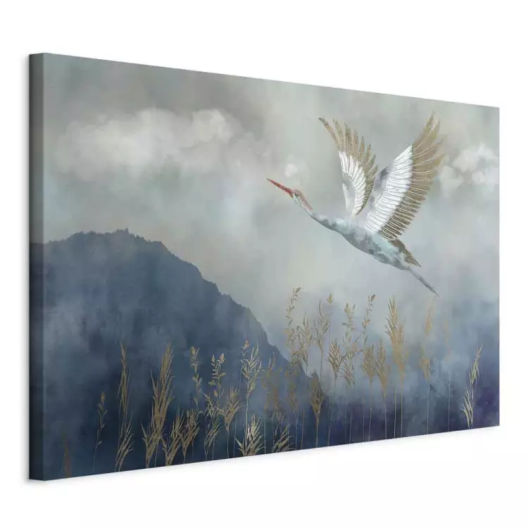 A Heron in Flight - A Bird Flying Against the Background of Dark Blue Mountains Covered With Fog
