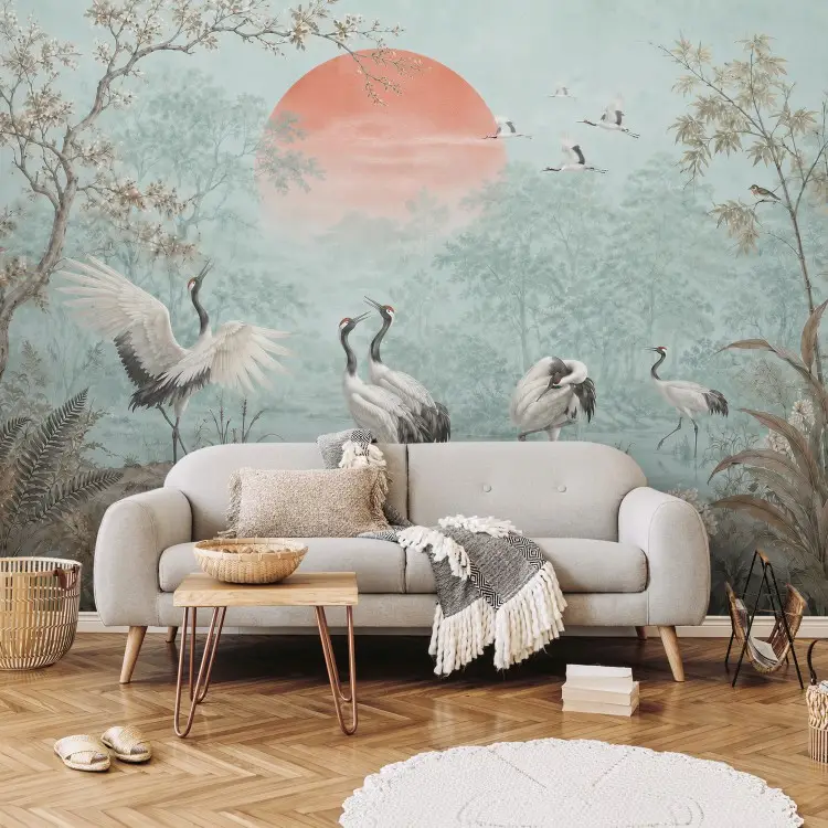 Rising sun - cranes wading in a river amidst a green forest