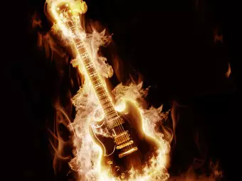 Wall Mural Rock Music - Electric guitar in flames on a black background Wallpaper Cropper
