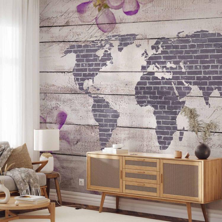 Wall Mural World of flowers - brick map of the world on a background of white boards with inscriptions