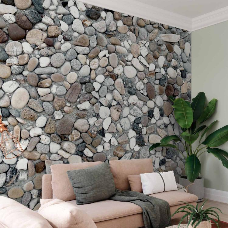 Wall Mural Gray Rocky Beach - Background with Uniform Motif of Various Stones on Sand