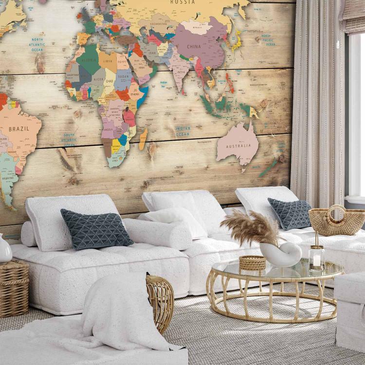 Wall Mural City states - a signed coloured world map on a background of wood planks