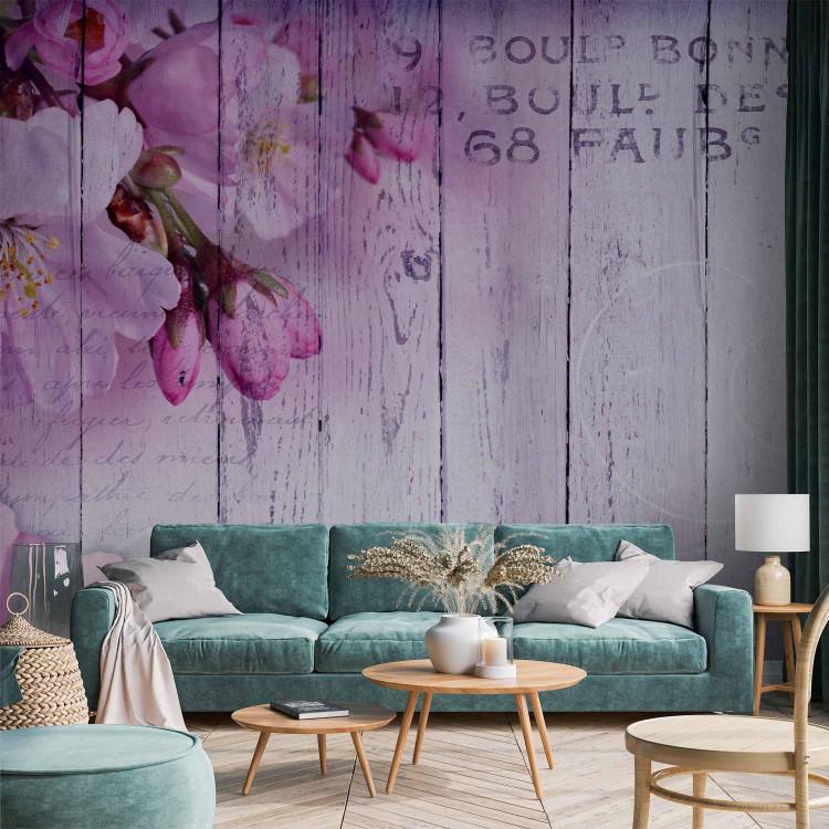 Wall Mural Apple blossoms - violet tones motif on wood textured background