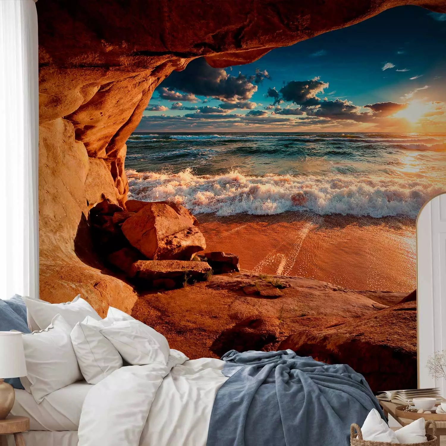 Wall Mural Cave by the beach - landscape with a restless sea at sunset