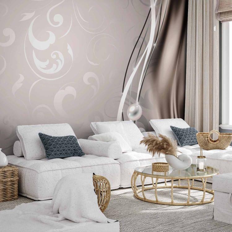 Wall Mural Subtlety - columns of pearls on a background with ornaments and a glow effect