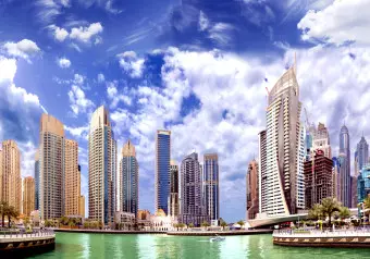 Wall Mural Dubai - white clouds against architecture with modern skyscrapers Wallpaper Cropper