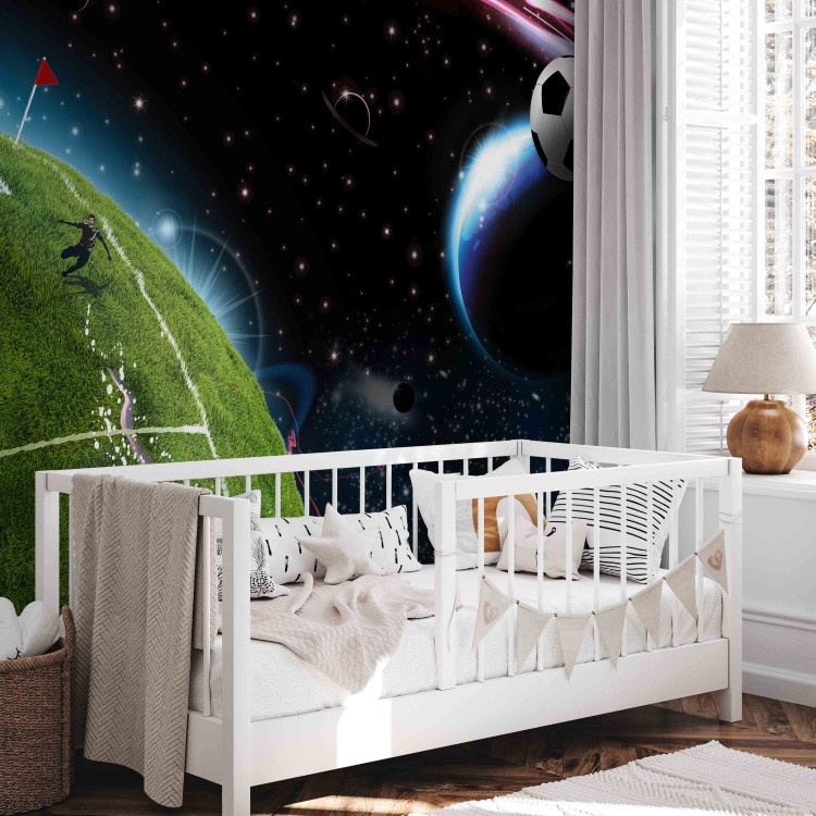 Wall Mural Cosmic Match - Soccer player playing on the field kicking the ball into space 61151 additionalImage 6