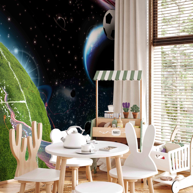Wall Mural Cosmic Match - Soccer player playing on the field kicking the ball into space 61151 additionalImage 5
