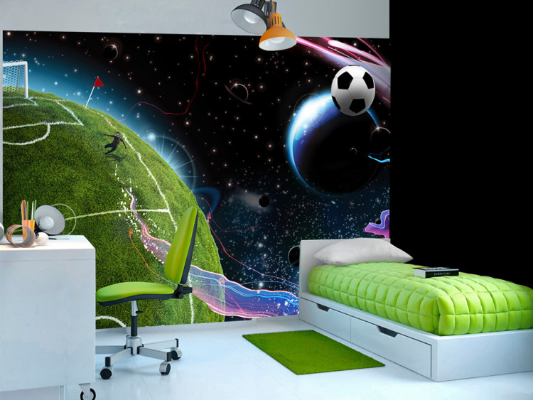 Wall Mural Cosmic Match - Soccer player playing on the field kicking the ball into space 61151