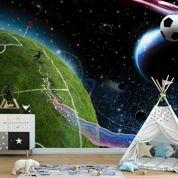 Wall Mural Cosmic Match - Soccer player playing on the field kicking the ball into space 61151 additionalImage 4