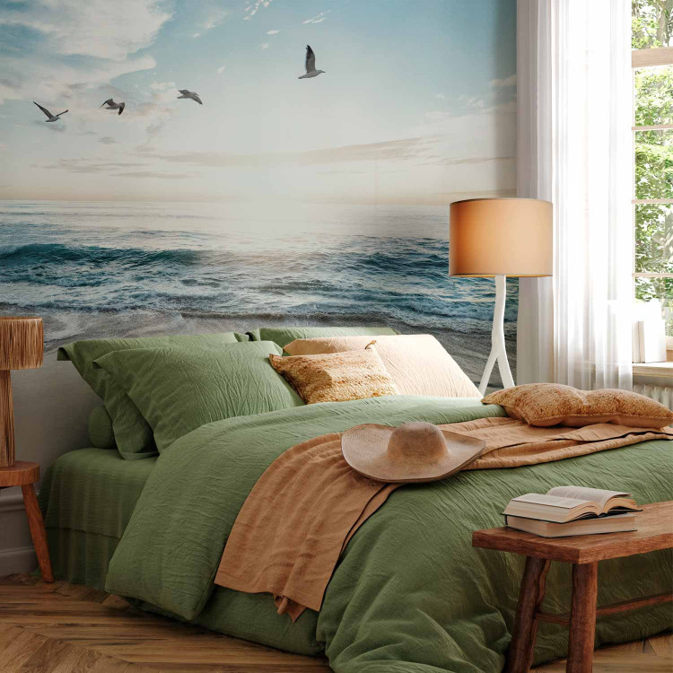 Wall Mural Abandoned beach - seascape with waves, birds and a setting sun 138461 additionalImage 2