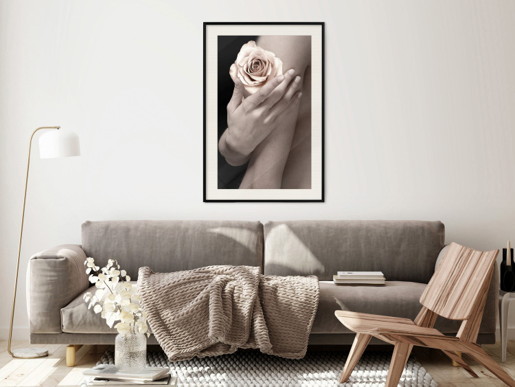 Wall Poster Subtle Fragrance - woman's hand holding rose flower on black background 128081 additionalImage 24