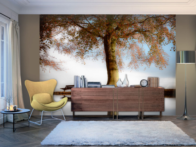 Wall Mural Tree by the Lake - Landscape with a Lonely Bench under a Blue Sky 60263