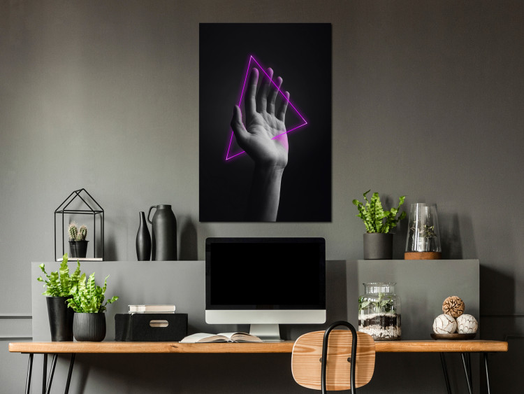 Canvas Print Triangle in hand - neon figure in the hand on black background 125083 additionalImage 3