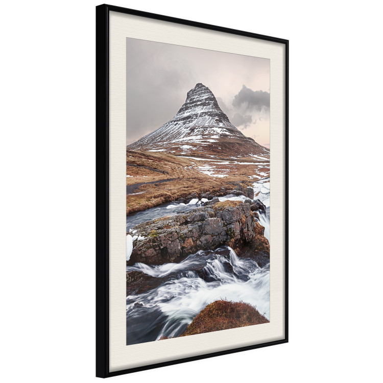 Wall Poster Kirkjufell - winter landscape of a mountain and a stream against the sky 130383 additionalImage 2