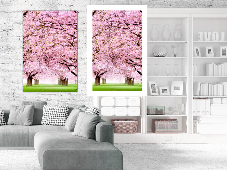 Wall Poster Cherry Orchard - landscape of green grass and trees with pink leaves 126214 additionalImage 2
