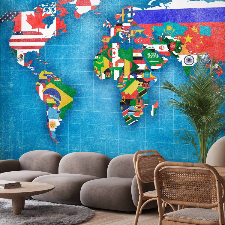 Wall Mural World map - motif of continents in flag colours on a blue background 96764