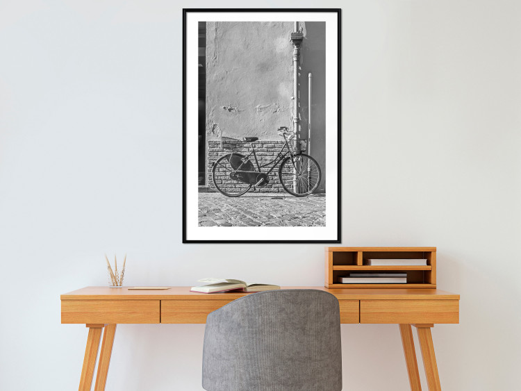 Wall Poster Old Italian Bicycle - black and white shot with a view of a stone street 117784 additionalImage 4