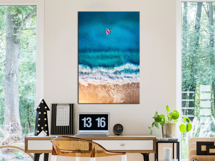 Canvas Print A moment of break - a figure sails to the sea on an inflatable wheel 116815 additionalImage 3