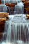 Wall Mural Beauty of Nature - Landscape of Waterfalls Flowing from the River over Rocks 60056