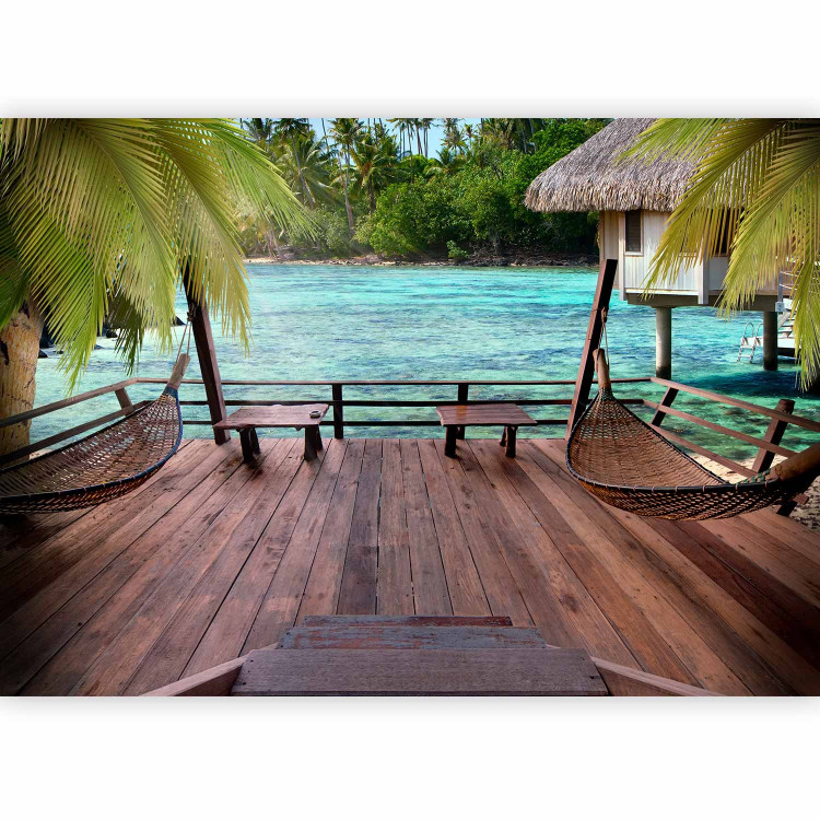 Wall Mural Tropical Landscape - Turquoise water with palm trees and wooden cottages 61707 additionalImage 1