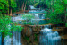 Photo Wallpaper Beauty of Nature - Landscape of Waterfalls Flowing into a Stony Lake 60047