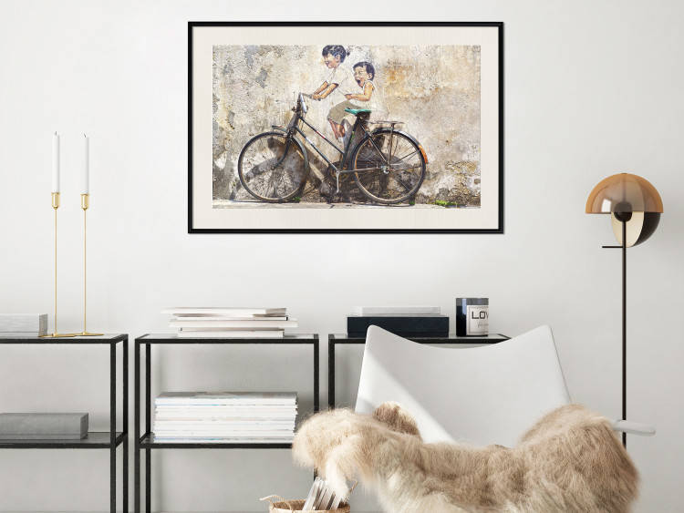 Poster Carefree - retro black bicycle against a wall painted with children 130457 additionalImage 24