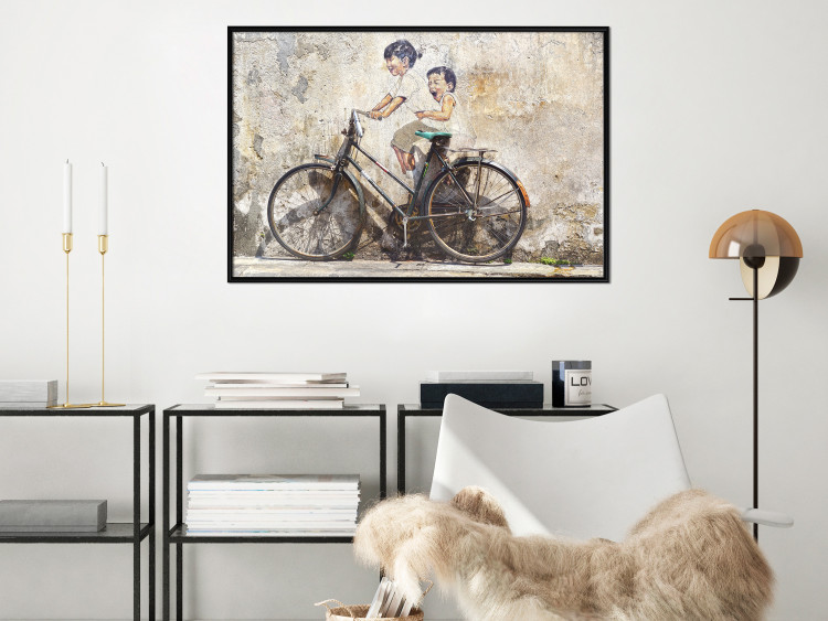 Poster Carefree - retro black bicycle against a wall painted with children 130457 additionalImage 7