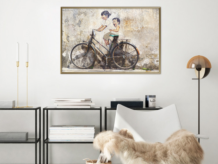 Poster Carefree - retro black bicycle against a wall painted with children 130457 additionalImage 6