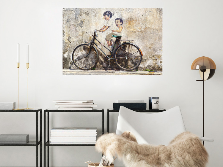 Poster Carefree - retro black bicycle against a wall painted with children 130457 additionalImage 5